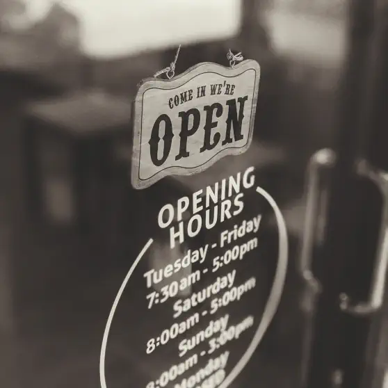 A sepia toned picture of an open sign in a window
